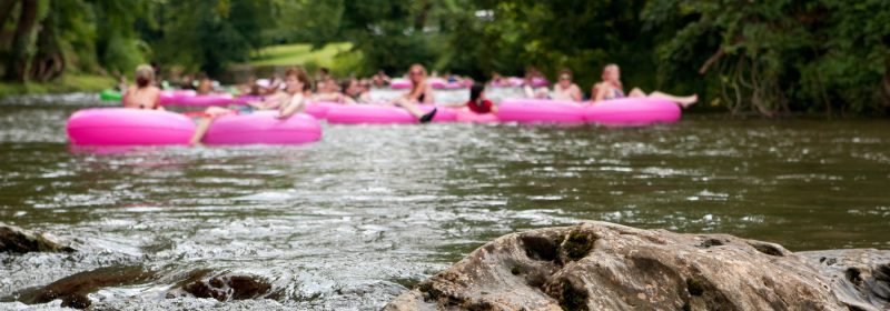 people floating on river